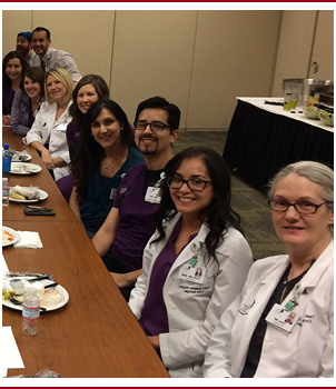 Employees pose at a table